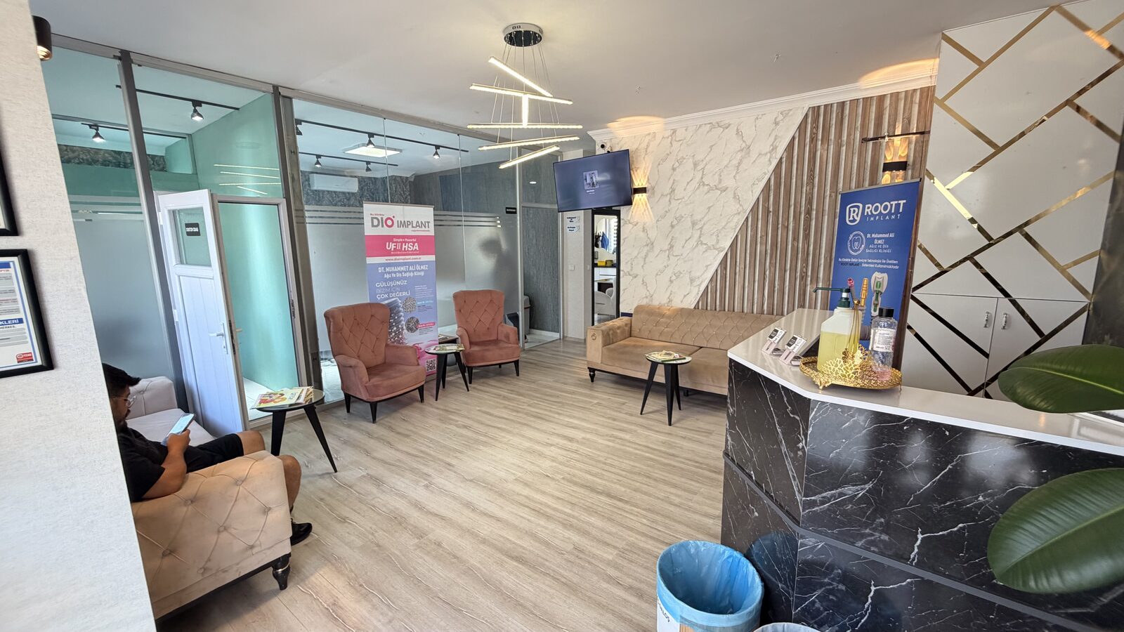 Bekleme salonunun geniş açılı görünümü; koltuklar ve banko.
